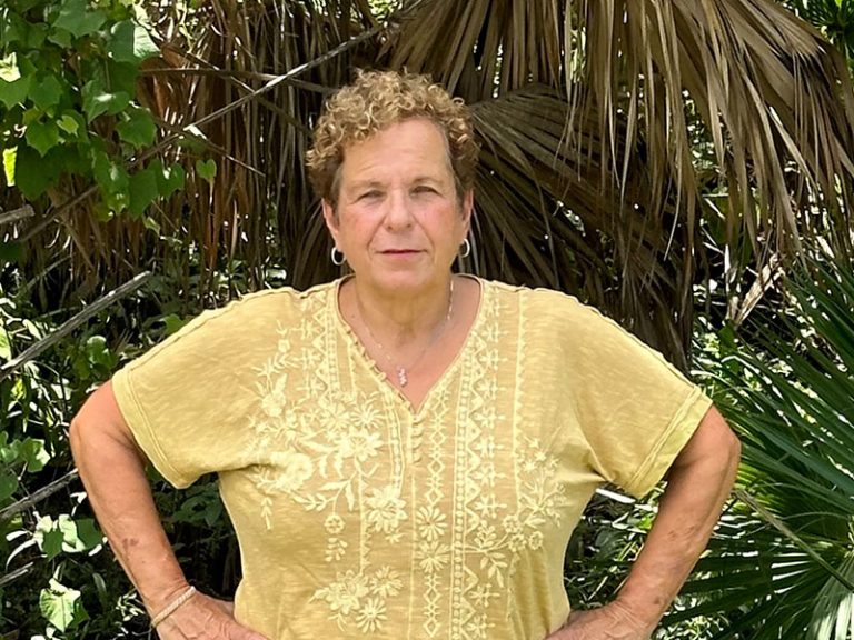Joan Iacono stands in front of trees in a Venice park site.